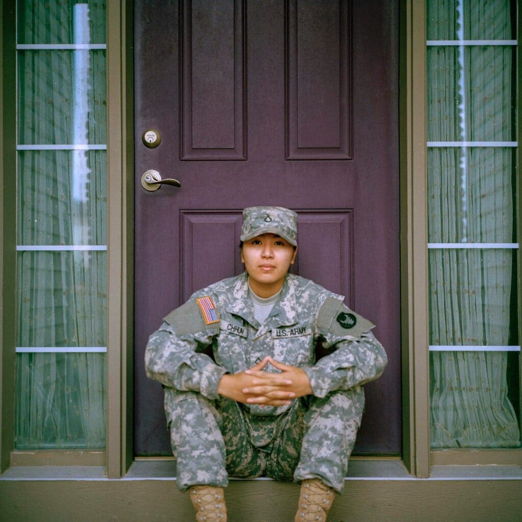 Army veteran woman sitting in front of closed door